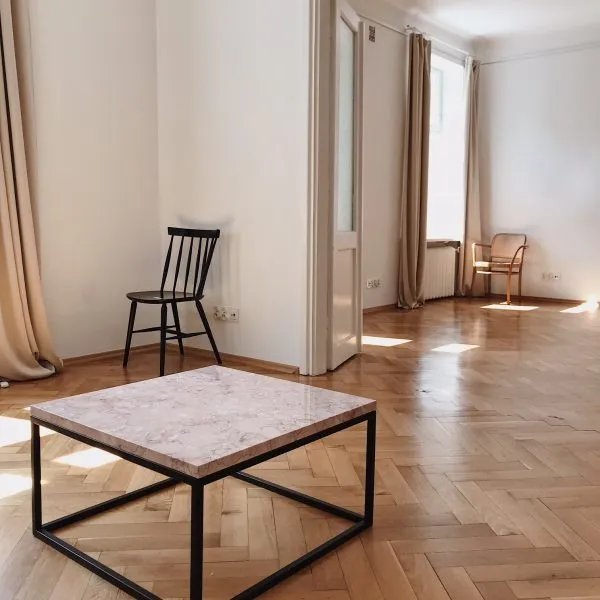 A marble topped coffee table in a room with parquet flooring